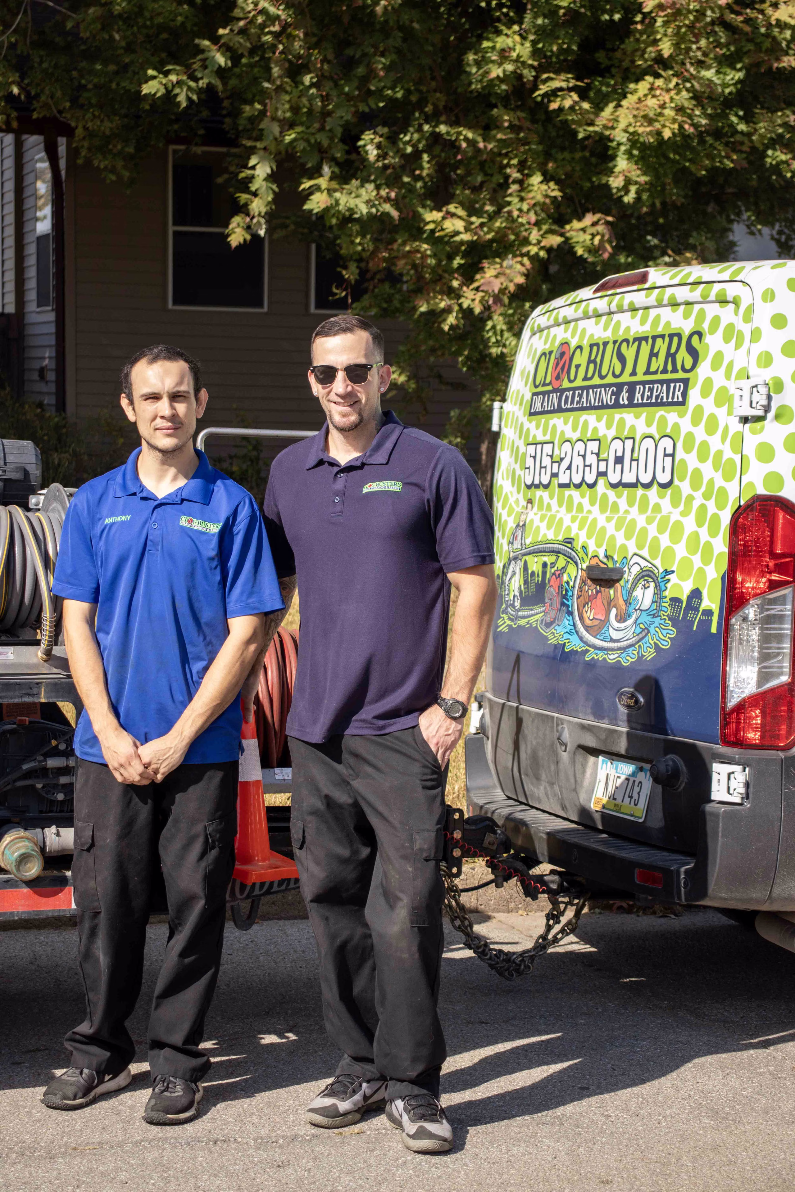 Clog Busters technicians with van and jetter trailer